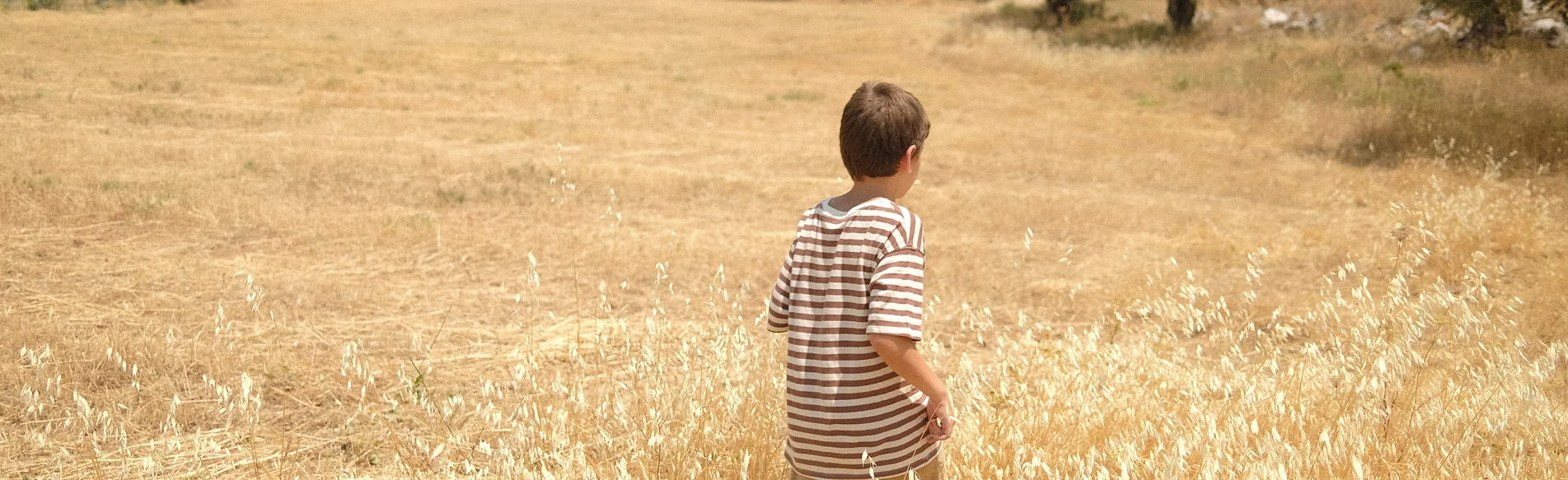 A child walking in grassland